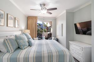 a bedroom with a bed and a ceiling fan at Gulfside 210 - 2BR plus bunkroom with Ocean & Pool Views in Fort Walton Beach +41 photos