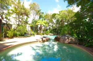 a swimming pool with an elephant in a yard at Raintrees Moffat Beach in Caloundra