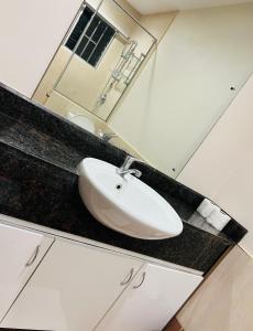 a bathroom counter with a sink and a mirror at Paradise Apartment Suva in Suva