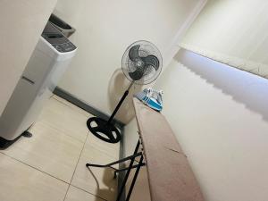 a fan in the corner of a room at Paradise Apartment Suva in Suva