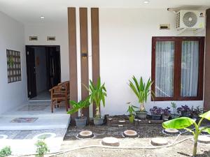a porch of a house with plants in it at Liefly Prambanan Villa in Randugunting +7 photos