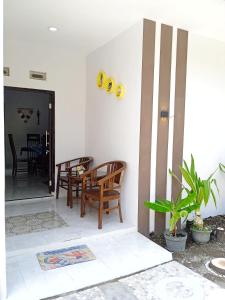 a living room with two chairs and a table at Liefly Prambanan Villa in Randugunting