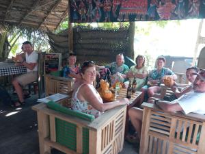 a group of people sitting in chairs at a restaurant at Blue Horizon Beach Hotel in Tangalle