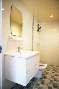 a bathroom with a sink and a toilet with a mirror at Happyhouse Laksi station (PK14) in Lak Si