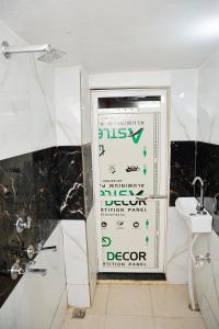 a bathroom with a sign on the door at Shree Home Stay in Ujjain +14 photos