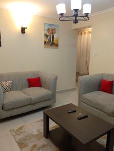 a living room with two couches and a coffee table at Sweet Homes Ngong Road in Nairobi