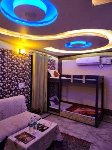 a room with a bed with a blue ceiling at Dk's Paradise Homestay in Agra