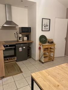 a kitchen with a stove and a counter top at La petite maison de Coline in Réville
