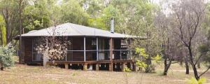 a wooden house in the middle of a forest at Unlax @ Hunter Valley in Pokolbin