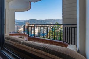 a balcony with a view of the mountains at POKHARA APARTMENTS INN in Pokhara