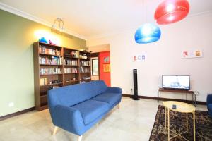 a living room with a blue couch and a tv at A Tranquil Retreat Near PWTC & KLCC in Kuala Lumpur