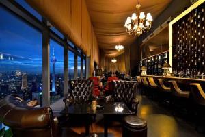 a bar with leather chairs and a view of a city at A Tranquil Retreat Near PWTC & KLCC in Kuala Lumpur