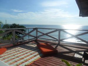 a balcony with a view of the ocean at Hotel Sol y Luna in Capurganá