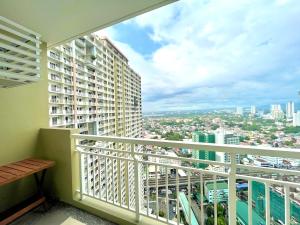 a balcony with a view of a city at mushROOM Condotel at Infina Towers, Quezon City in Manila