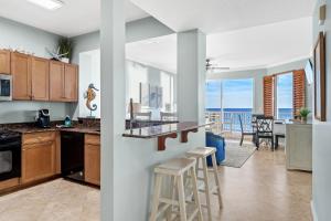 a kitchen and living room with a view of the ocean at Gulfside 402 - True Luxury BEACHFRONT at Destin West - Best View in the Resort! in Fort Walton Beach