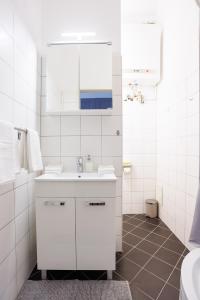 a white bathroom with a sink and a mirror at #29 Heaven Messe/Prater in Vienna