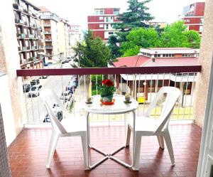 a table and chairs on a balcony with a view of a city at 15 minuti al Centro Torino con Tram 4 - Lingotto relax, Inalpi Arena, Stadio in Turin