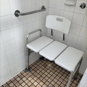 a white bench in a bathroom with a toilet at Wangaratta Motor Inn in Wangaratta