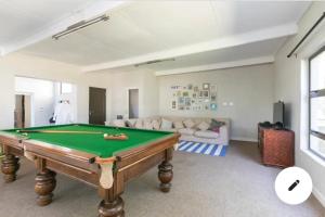 a living room with a pool table and a couch at The Urban Farmhouse: Find Peace&Rest@the Farmhouse in Chartwell