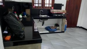 a kitchen with a sink and a counter top at Family Villa Thalpavila in Ambatenna