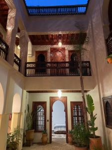 a large room with a hallway with a ceiling at Riad Amalia in Marrakech