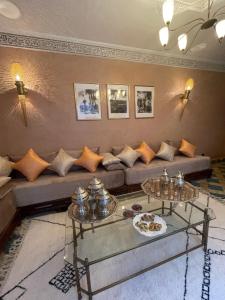 a living room with a couch and two tables at Riad Amalia in Marrakech