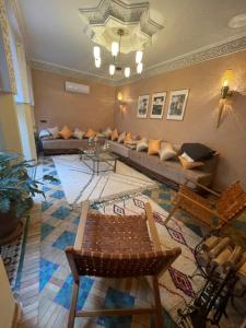 a living room with a couch and a table at Riad Amalia in Marrakesh