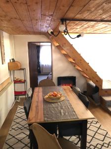 a dining room with a table and some chairs at Parâng View in Petroşani