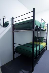a couple of bunk beds in a room at Kareem Syariah Hostel Bukittinggi in Bukittinggi
