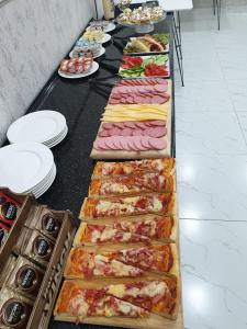a buffet line with many different types of pizzas at Hotel Sevinch in Tashkent