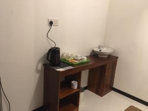 a bathroom with a sink and a coffee maker on a table at Ella Panorama Villa in Ella