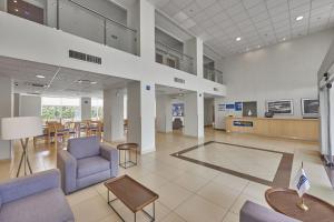 a lobby with chairs and tables in a building at City Express by Marriott Culiacan in Culiacán