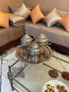a silver tea set on a table in a living room at Riad Amalia in Marrakech
