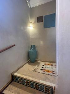 a blue vase sitting on a floor in a room at Riad Amalia in Marrakech