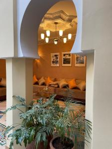 a living room with a couch and some plants at Riad Amalia in Marrakech