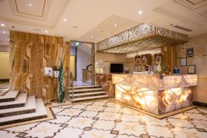 a lobby of a hotel with a marble counter at The Glorious Hotel in Al Madinah