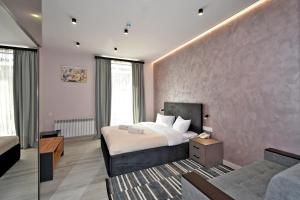 a hotel room with a bed and a couch at Avenue 23 Boutique Hotel in Yerevan