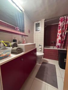 a bathroom with a sink and a toilet at Smile Stay Apartment in Alexandroupoli