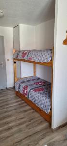 une chambre avec deux lits superposés dans une pièce dans l'établissement Bernex T2 toute saison au pied des pistes, à Bernex