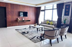 a living room with a couch and a table at Grand Inna Samudra Beach in Cimaja