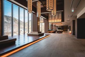a lobby with a view of a mountain through the windows at Grand Blissen Hotel Jozankei in Jozankei