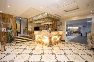 a lobby of a hotel with a marble floor at The Glorious Hotel in Al Madinah