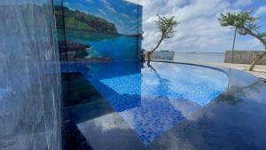 a pool with blue tile on the side of a building at ChanKy Hotel Dao Phu Quy in Cu Lao Thu