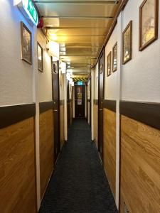 a corridor of a hallway with wooden walls and a corridorngthngthngthngthngth at Den Röda Båten in Stockholm
