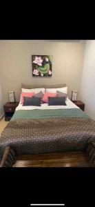 a bedroom with a large bed with pink pillows at Relax and Rejuvenate in Rayong! in Rayong