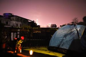 a person standing next to a tent in front of a train at Changsha Fuxiangyuan International Hostel in Changsha