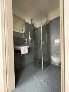 a bathroom with a shower and a sink and a toilet at Workbase Hostel in Vienna +10 photos