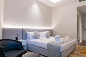 a bedroom with a bed with a teddy bear on it at eStay Hotel in Dubai