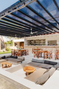 an outdoor patio with wooden tables and benches at Bora Boutique - Adults Only in Puerto Escondido +56 photos