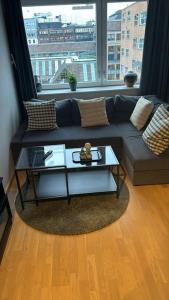 a living room with a couch and a table at Amazing apartment by Opera house in Oslo